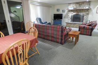 dining room and living room with tv and fireplace